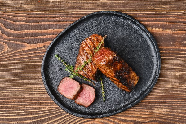 Top view of grilled beef brisket flat steak on wooden table