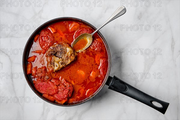 Slow cooking food. Bottom round roast beef meat stew with tomatoes and carrot