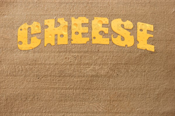Title cheese on cardboard background
