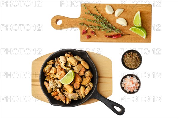 Boiled mussels and spice ready for frying isolated on white background