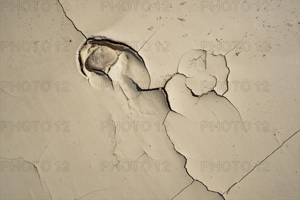 A rock sunk in dry mud. Due to the drought