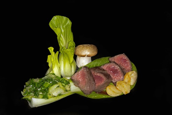 Medium roasted venison fillet with pak choi