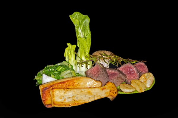 Medium roasted venison fillet with pak choi