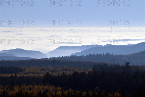 View from Moerschieder Burr mountain in the Hunsrueck-Hochwald National Park over the Naheland and North Palatinate mountains on a misty autumn morning