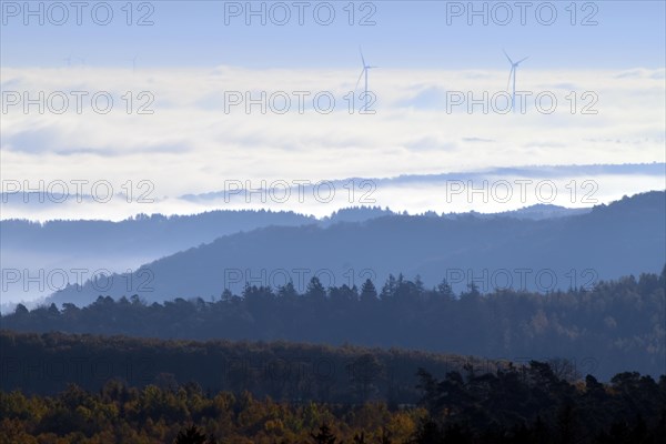 View from Moerschieder Burr mountain in the Hunsrueck-Hochwald National Park over the Naheland and North Palatinate mountains on a misty autumn morning