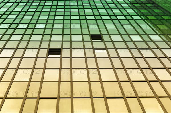 Glass facade of an office tower with two open windows