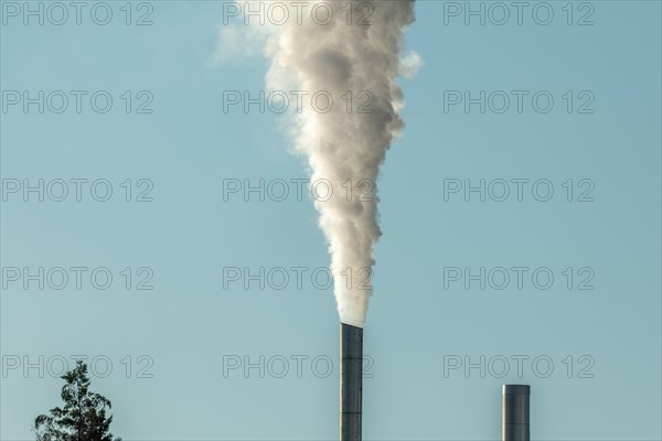 Column with smoke coming out of an industrial chimney. France