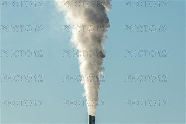 Column with smoke coming out of an industrial chimney. France