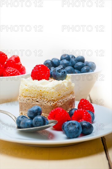 Fresh homemade raspberry and blueberry cream cake