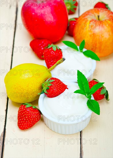 Fresh fruits and whole milk yogurt on a rustic wood table