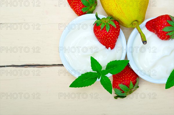 Fresh fruits and whole milk yogurt on a rustic wood table