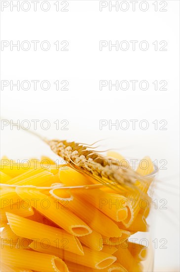 Short Italian pasta penne with durum wheat grains