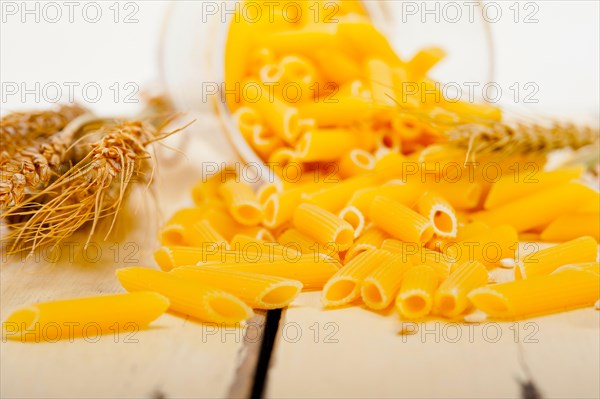 Short Italian pasta penne with durum wheat grains