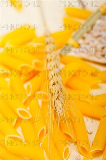 Short Italian pasta penne with durum wheat grains