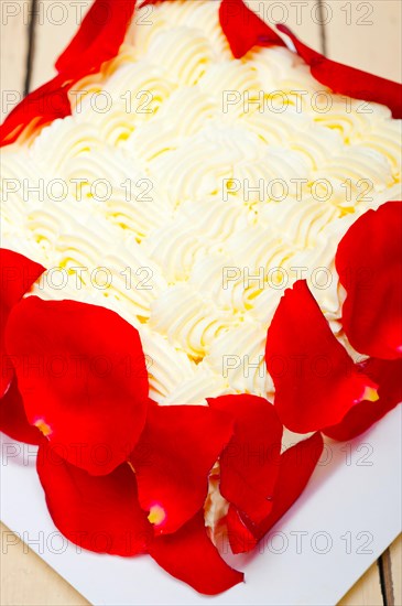 Whipped cream mango cake with red rose petals