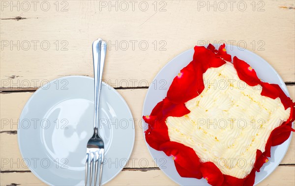 Whipped cream mango cake with red rose petals