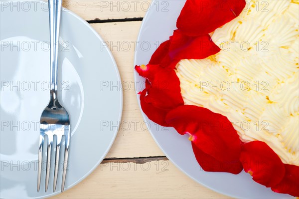 Whipped cream mango cake with red rose petals