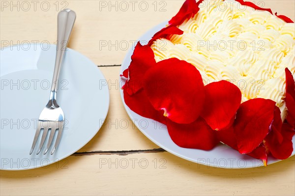 Whipped cream mango cake with red rose petals