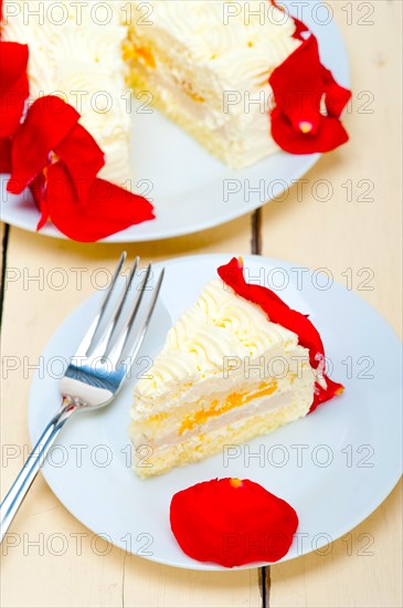 Whipped cream mango cake with red rose petals