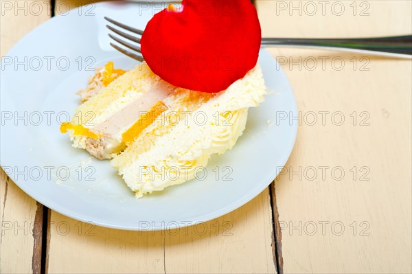 Whipped cream mango cake with red rose petals