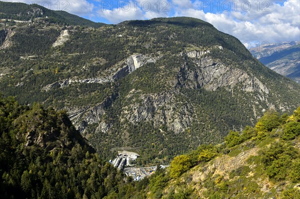 Construction site of the A9 motorway for the Visp tunnel in a deep valley of the Valais Alps