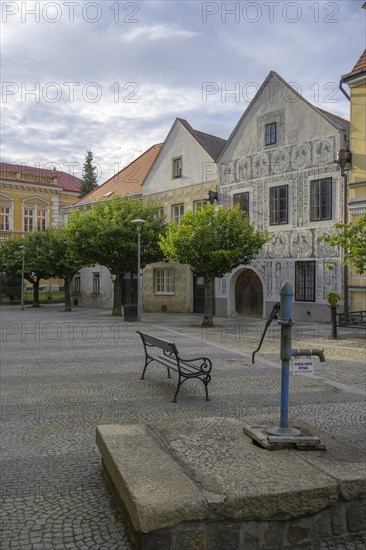 Historical old town with sgraffito house and old fountain