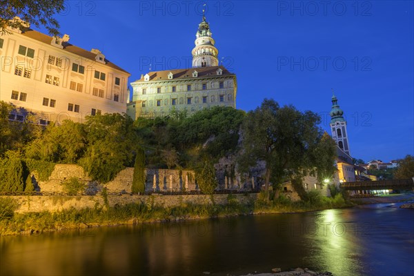 Vltava river and castle with Zamecka vez tower in the evening