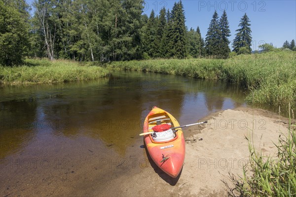 Paddle boat on a small sandy beach on the Vltava River