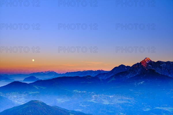 The peaks of Hoher Dachstein and hoher Goell in the last evening light and moonrise