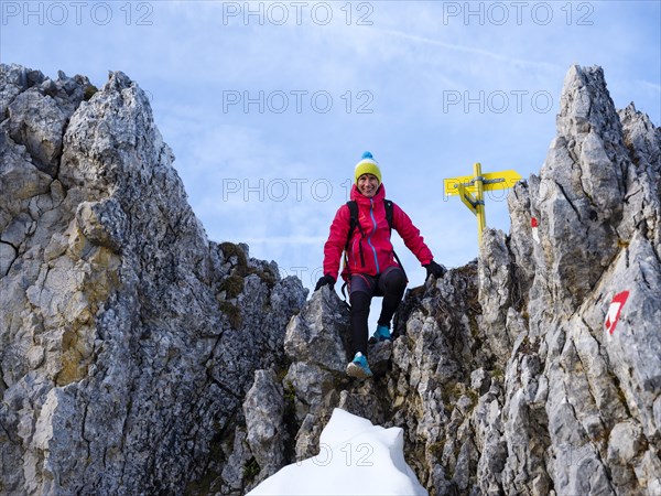 Mountaineer climbing over a rocky saddle