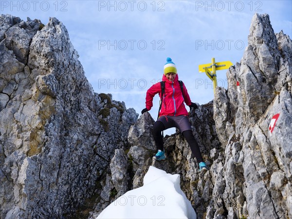 Mountaineer climbing over a rocky saddle