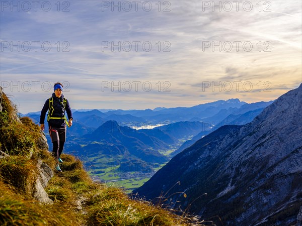 Mountaineer walking on a narrow path above the Salzach valley