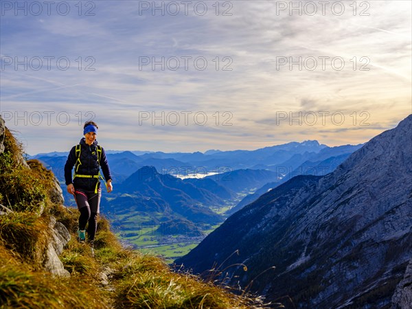 Mountaineer walking on a narrow path above the Salzach valley