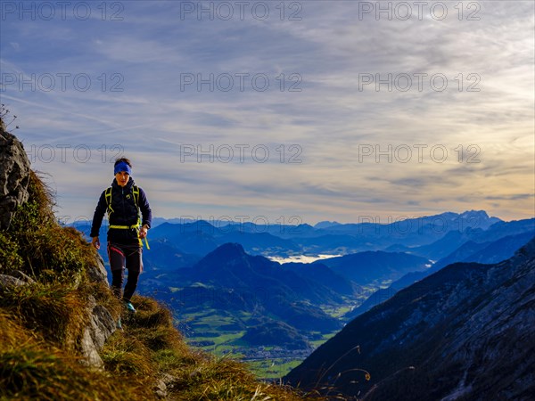 Mountaineer walking on a narrow path above the Salzach valley