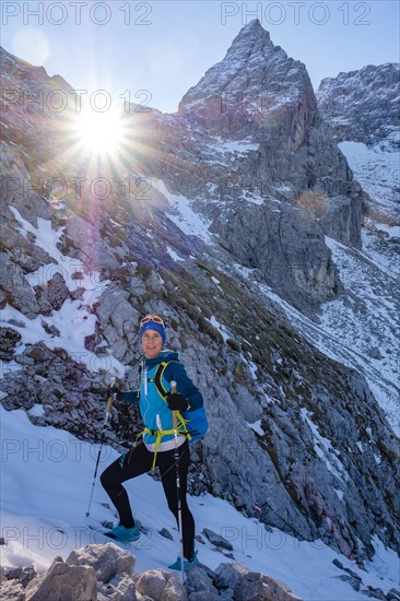 Mountaineer climbing upwards in snowy