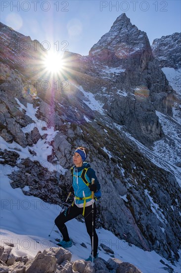 Mountaineer climbing upwards in snowy