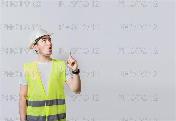 Engineer man pointing up. Surprised face engineer pointing finger to the right
