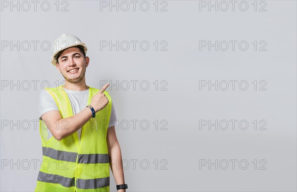 Engineer man pointing to side. Builder engineer pointing finger to the right isolated