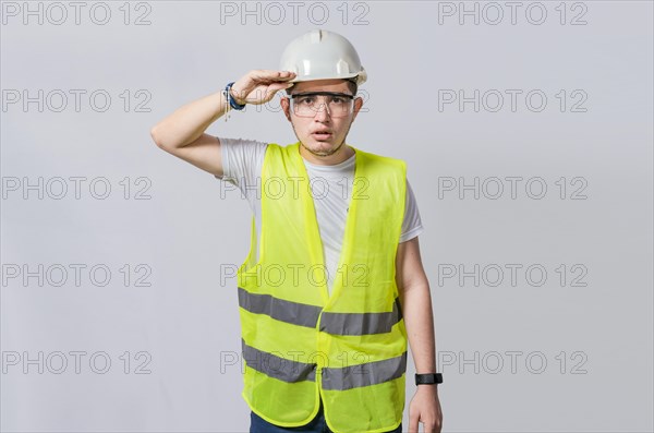 Handsome engineer looking into the distance isolated