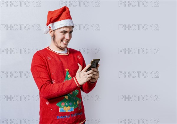 People in santa hat using and smiling at cellphone isolated