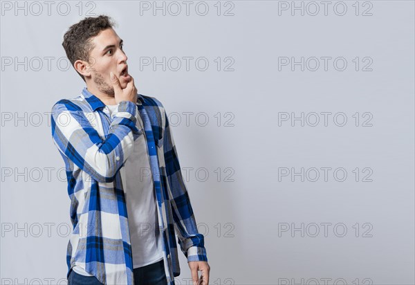 Bearded guy with surprised face with open mouth looking to the side