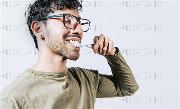 Man brushing his teeth isolated