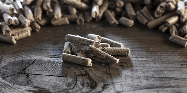 Wood pellets on wooden background