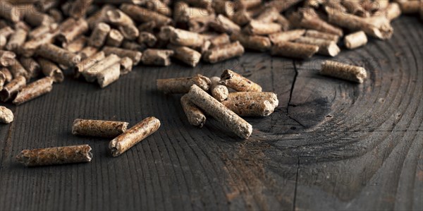 Wood pellets on wooden background