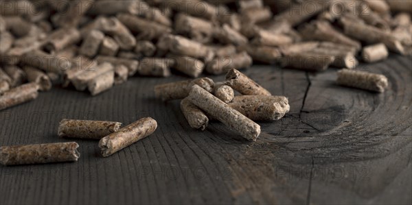 Wood pellets on wooden background