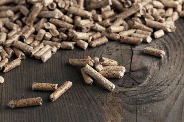 Wood pellets on wooden background