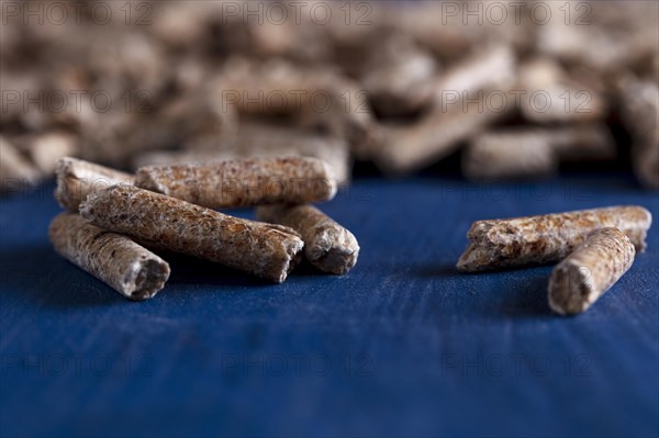 Wood pellets on a blue wooden background