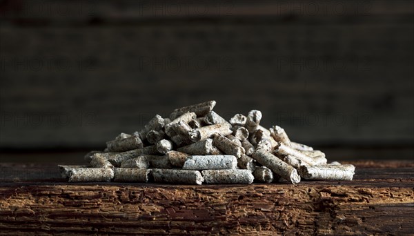 Wood pellets on wooden background