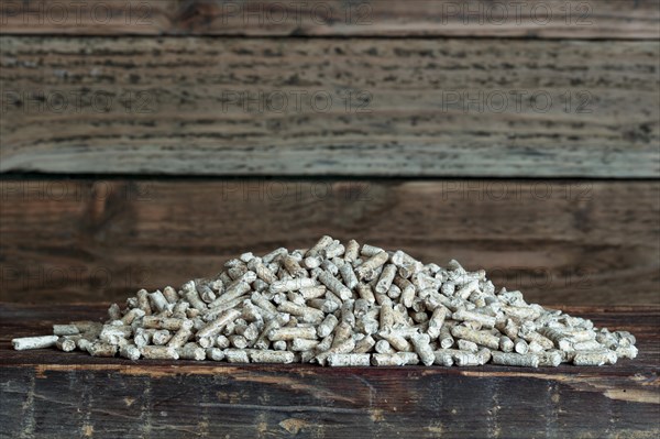 Wood pellets on wooden background