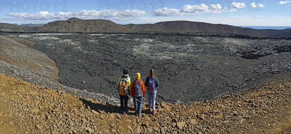 Hikers look down on solidified lava